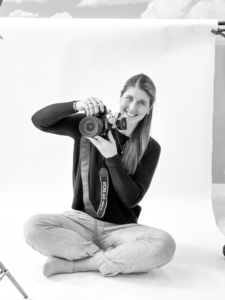 smiling women holding camera