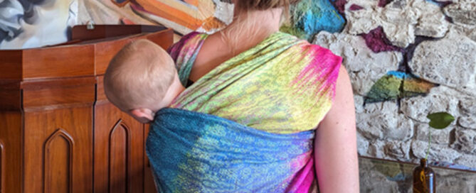 mom and baby demonstrating a baby carrying sling